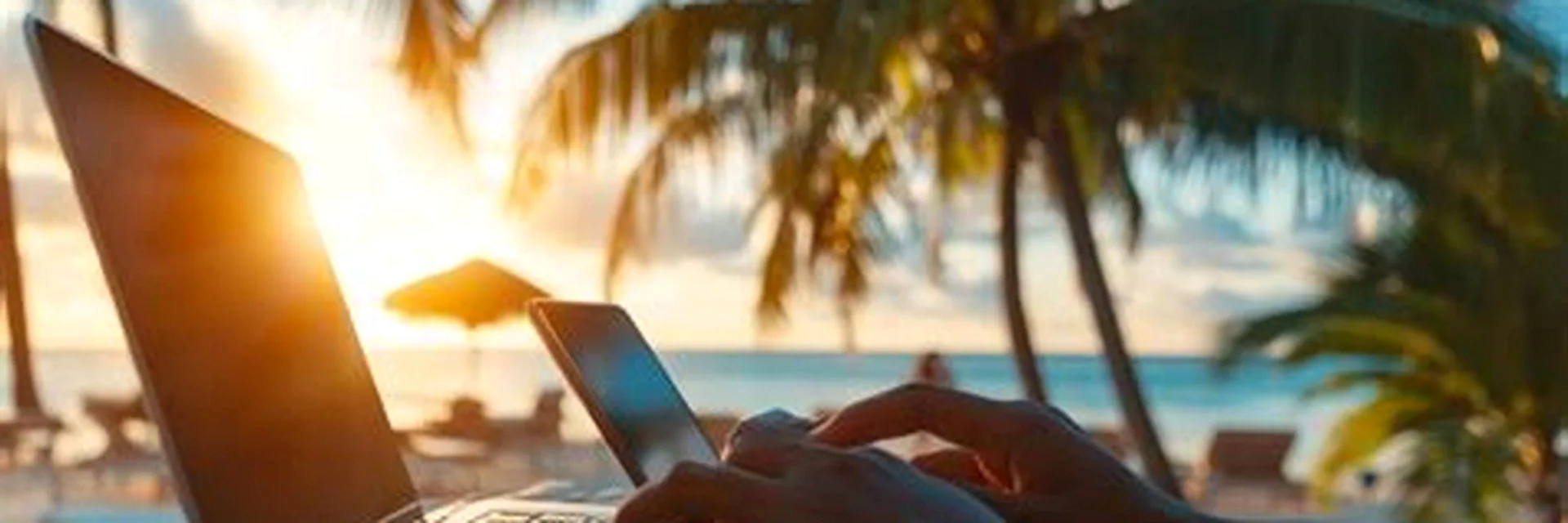 Playing Calypso Casino online from a laptop browser on a palm-lined beach